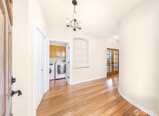 549 E Maberry Dr, Lynden, WA 98264 - hall featuring washing machine and clothes dryer, a chandelier, french doors, light wood finished floors, and baseboards