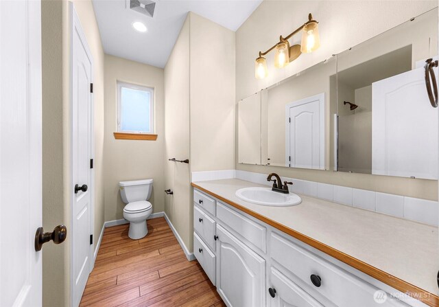 549 E Maberry Dr, Lynden, WA 98264 - full bathroom with vanity, hardwood / wood-style floors, toilet, baseboards, and a shower