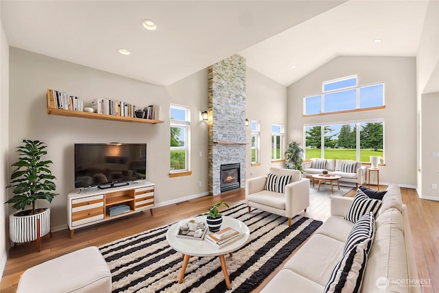 549 E Maberry Dr, Lynden, WA 98264 - living room featuring wood finished floors, a fireplace, high vaulted ceiling, and baseboards