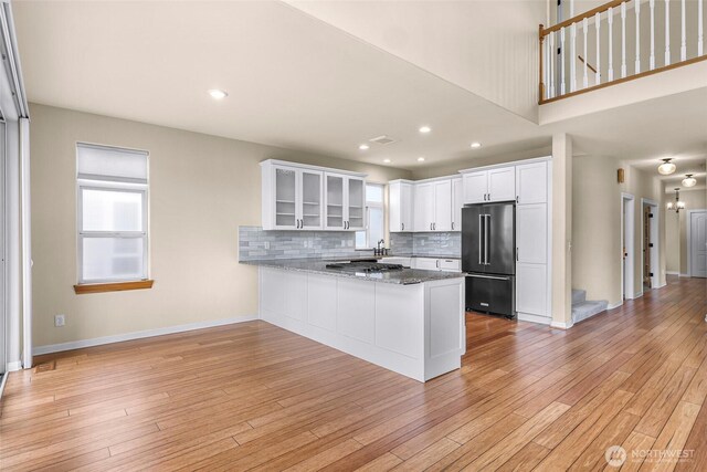 549 E Maberry Dr, Lynden, WA 98264 - kitchen with high end refrigerator, white cabinets, a peninsula, healthy amount of natural light, and recessed lighting