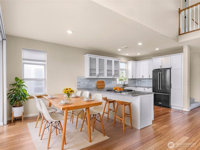549 E Maberry Dr, Lynden, WA 98264 - kitchen with high end fridge, a peninsula, glass insert cabinets, tasteful backsplash, and white cabinetry
