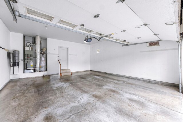 549 E Maberry Dr, Lynden, WA 98264 - garage with a garage door opener, strapped water heater, and heating unit