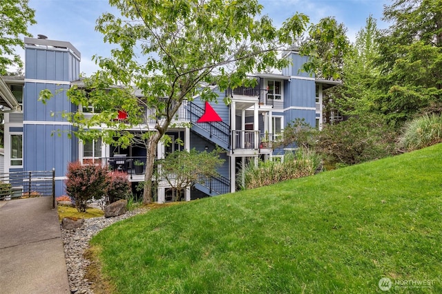surrounding community featuring stairs and a lawn