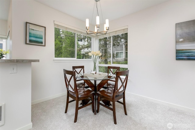 dining space featuring baseboards, a chandelier, and carpet floors