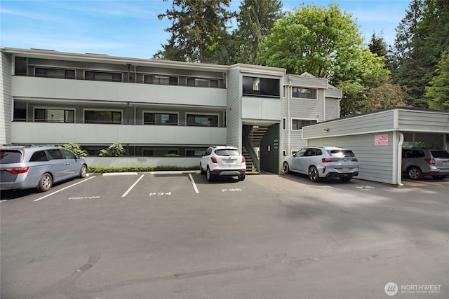 view of building exterior with uncovered parking