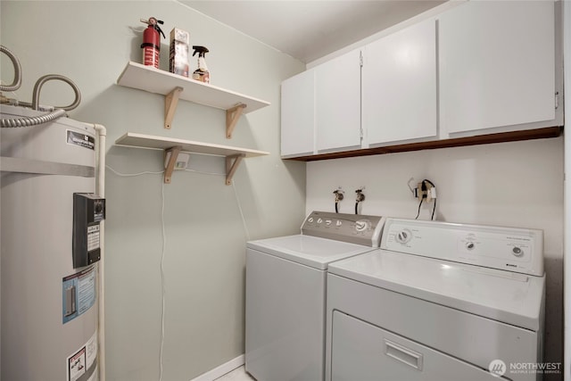 laundry area featuring electric water heater, cabinet space, and washer and clothes dryer