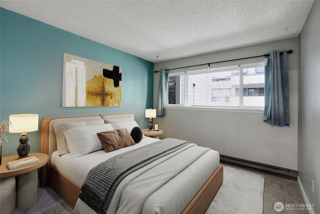 13739 15th Ave NE Unit B9, Seattle, WA 98125 - bedroom featuring a textured ceiling, baseboard heating, carpet, and baseboards