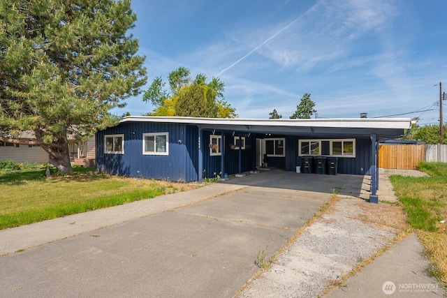 2008 S Belair Dr, Moses Lake, WA 98837 - ranch-style house with asphalt driveway, board and batten siding, and an attached carport