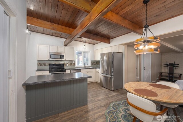 2008 S Belair Dr, Moses Lake, WA 98837 - kitchen with appliances with stainless steel finishes, dark countertops, tasteful backsplash, dark wood-style flooring, and a chandelier