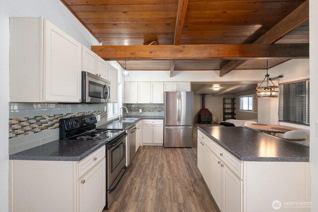 2008 S Belair Dr, Moses Lake, WA 98837 - kitchen with appliances with stainless steel finishes, dark countertops, wood ceiling, white cabinetry, and beam ceiling