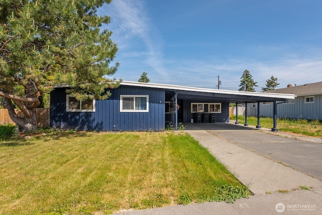 2008 S Belair Dr, Moses Lake, WA 98837 - view of front facade featuring a front lawn, an attached carport, board and batten siding, and driveway