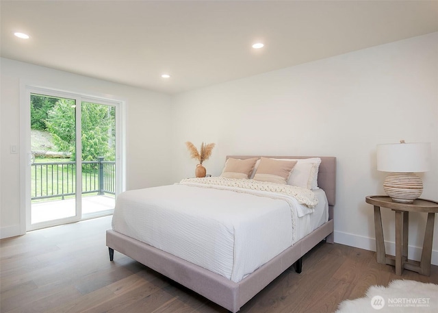 bedroom with access to outside, wood finished floors, recessed lighting, and baseboards