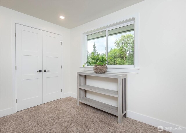 carpeted bedroom featuring a closet, recessed lighting, and baseboards