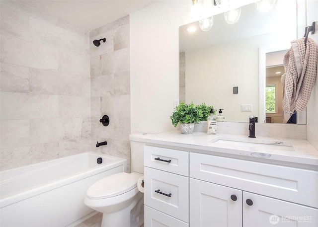 bathroom with toilet,  shower combination, and vanity