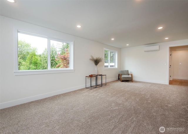 unfurnished room featuring an AC wall unit, recessed lighting, carpet flooring, and baseboards