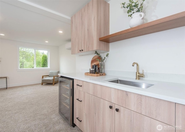kitchen with light brown cabinets, beverage cooler, a sink, light countertops, and open shelves
