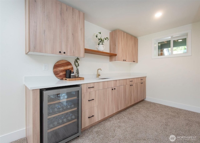 bar featuring wine cooler, a sink, baseboards, and light carpet