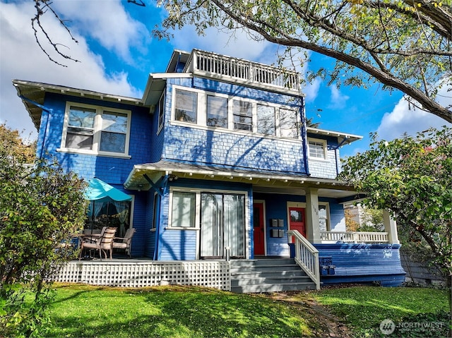 1808 E Harrison St, Seattle, WA 98112 - view of front facade with a porch, a front lawn, and a balcony