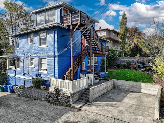 1808 E Harrison St, Seattle, WA 98112 - view of front of house featuring stairs, a deck, and a patio area
