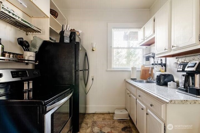 1808 E Harrison St, Seattle, WA 98112 - kitchen featuring electric range, a sink, baseboards, light countertops, and white cabinetry