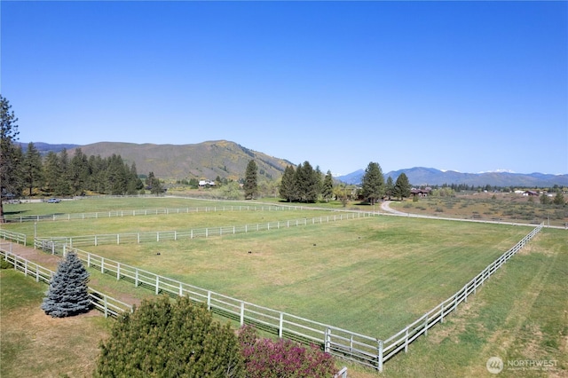 view of mountain background featuring rural landscape and a pastoral area
