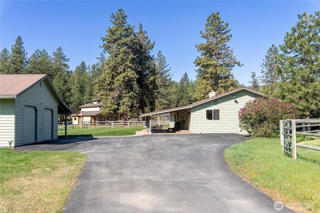 single story home with a garage and an outbuilding