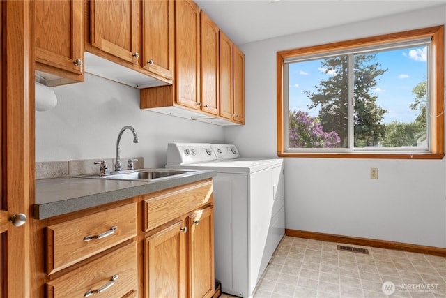 laundry area with cabinet space, baseboards, and separate washer and dryer