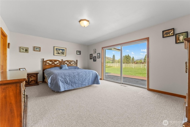 carpeted bedroom featuring access to outside and baseboards
