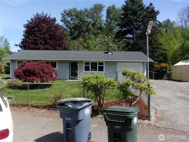 ranch-style home featuring fence, an attached garage, and concrete driveway