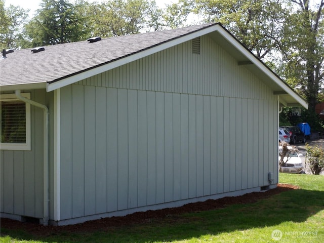 view of property exterior featuring roof with shingles and a yard