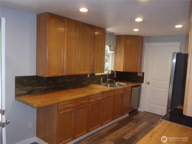 kitchen with a sink, fridge, dishwasher, decorative backsplash, and dark wood-style floors