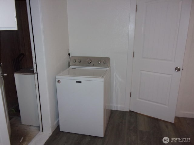clothes washing area with washer / dryer and dark wood finished floors