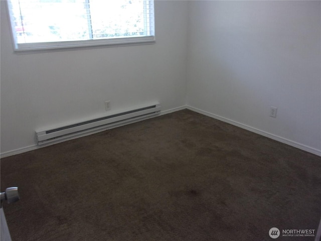 unfurnished room featuring a baseboard heating unit, plenty of natural light, dark carpet, and baseboards