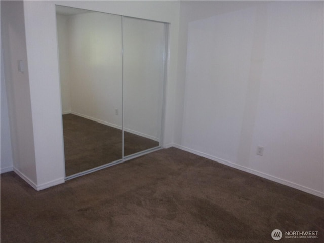 unfurnished bedroom featuring carpet, a closet, and baseboards