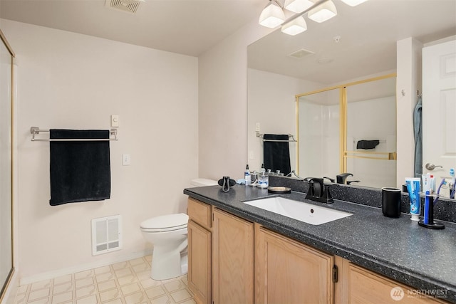 full bath featuring tile patterned floors, a shower stall, vanity, and toilet