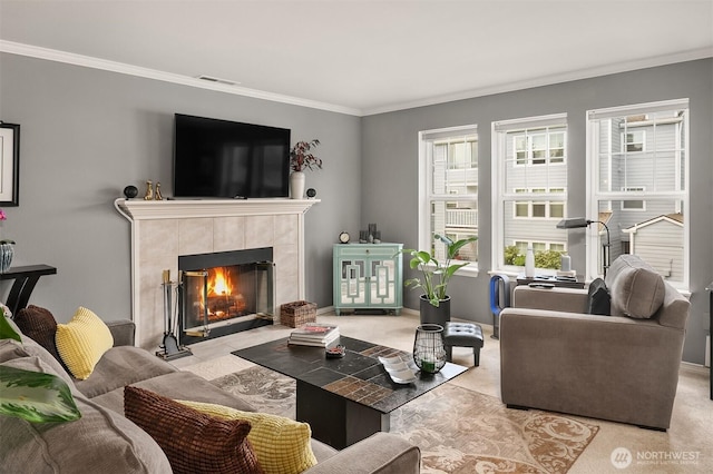living room featuring a fireplace, healthy amount of natural light, crown molding, and light carpet