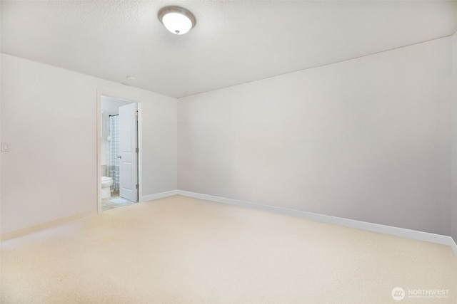unfurnished room featuring carpet flooring and baseboards