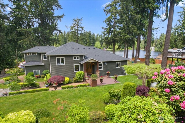 35449 34th Ave S, Auburn, WA 98001 - view of front of property featuring a front lawn, a patio area, a water view, roof with shingles, and view of wooded area