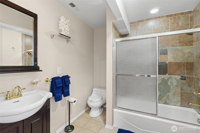 35449 34th Ave S, Auburn, WA 98001 - bathroom featuring toilet, vanity, tile patterned flooring, bath / shower combo with glass door, and baseboards