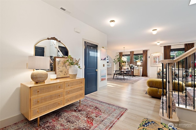 foyer entrance with wood finished floors and baseboards