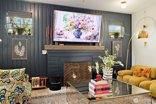 living area with healthy amount of natural light and a fireplace with flush hearth
