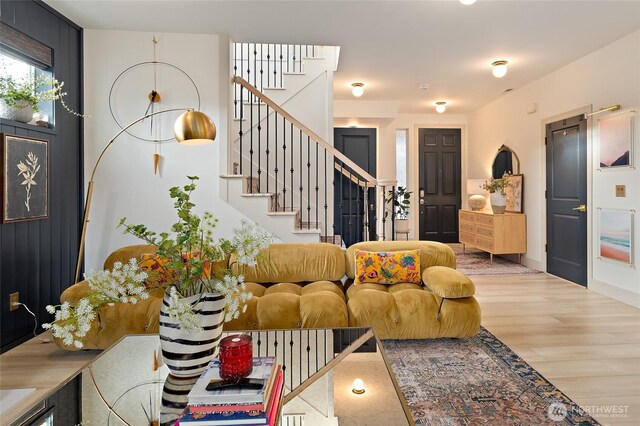 living room featuring wood finished floors and stairs