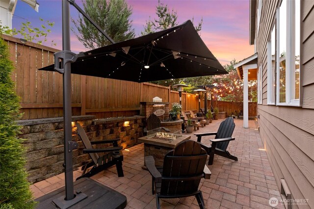 view of patio featuring a fire pit and a fenced backyard