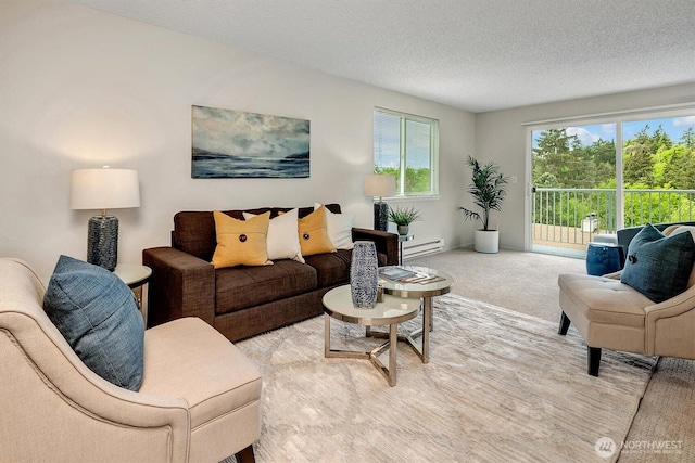 living room with a baseboard heating unit, a textured ceiling, and carpet floors