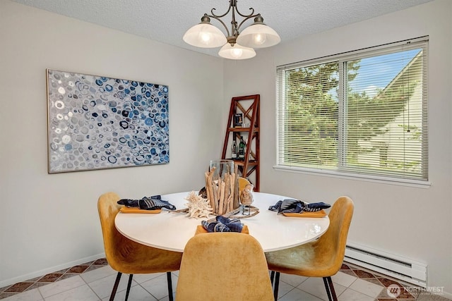 dining room with a baseboard heating unit, a chandelier, light tile patterned flooring, baseboards, and a textured ceiling