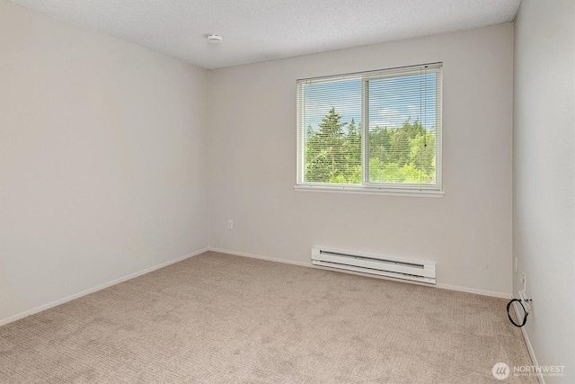 carpeted spare room featuring baseboard heating, baseboards, and a textured ceiling
