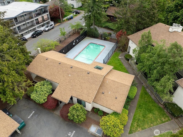 aerial view of property and surrounding area featuring a pool