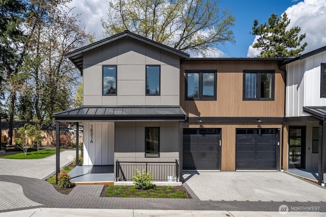 1831 4th St Unit A, Kirkland, WA 98033 - view of front of property featuring a standing seam roof, decorative driveway, an attached garage, metal roof, and covered porch