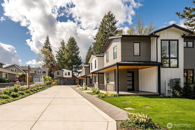 1831 4th St Unit A, Kirkland, WA 98033 - view of front of home with a residential view, a garage, board and batten siding, and a front yard