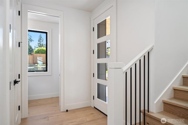 1831 4th St Unit A, Kirkland, WA 98033 - entrance foyer with light wood-style flooring, baseboards, and stairway